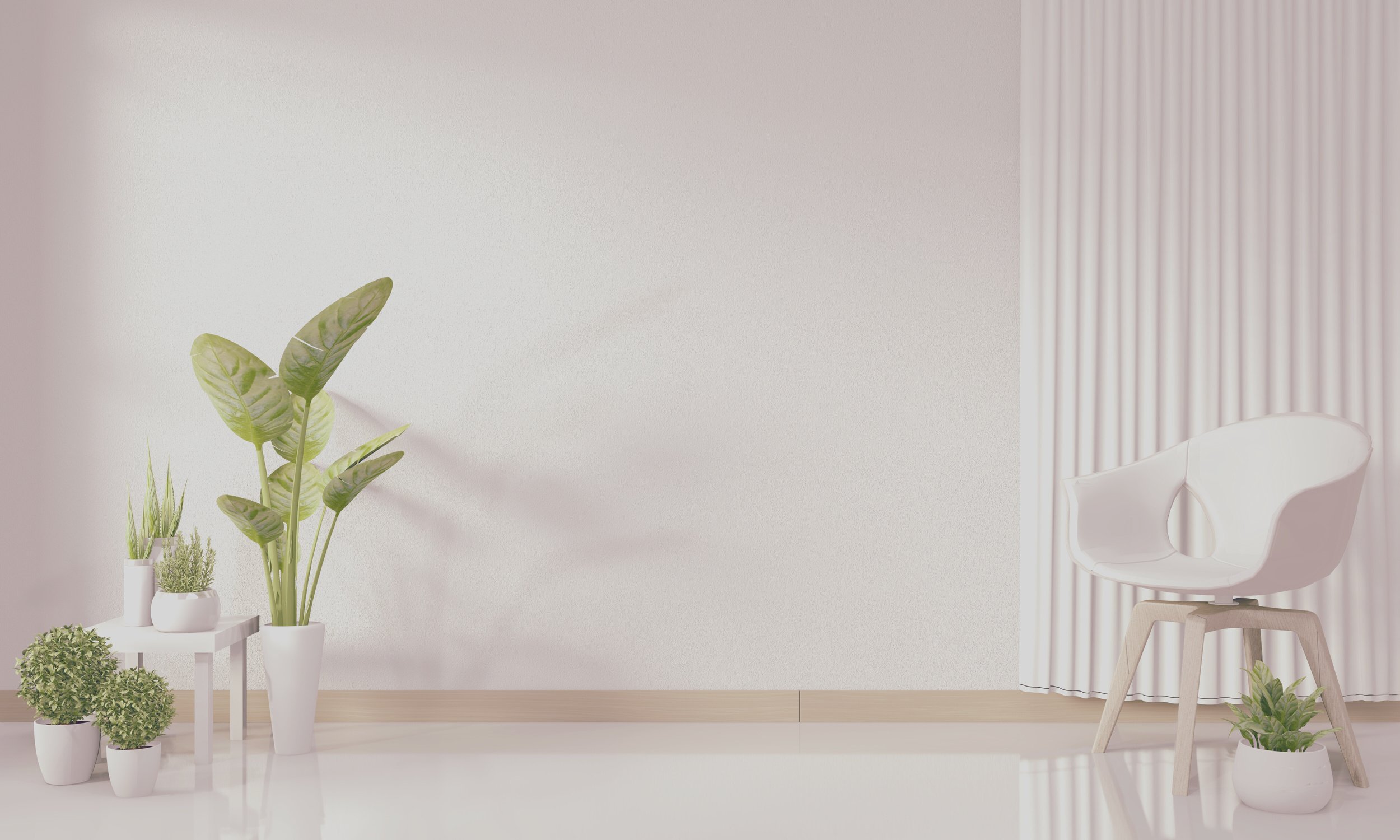 a room with a white chair and potted plants